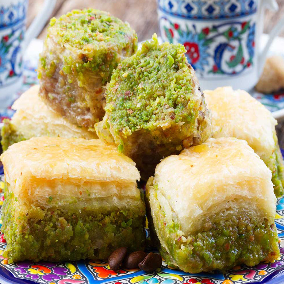 A rich mix of Middle Eastern Premium Baklava made from fine sheets or shredded phyllo dough, layered with carefully picked Pistachios, then using purified butter, baked and soaked in our special sugar syrup. Sugar-free baklava available.