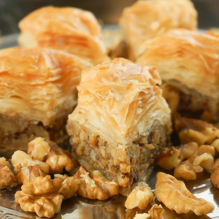 A rich mix of Middle Eastern Arabic Premium Baklava made from fine sheets or shredded phyllo dough, layered with carefully picked Walnuts, then baked using purified butter, and soaked in our special sugar syrup. Sugar-free baklava available.